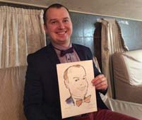 Довольный Виталий держит свой шарж